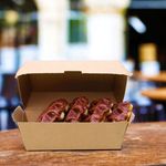 Eco-friendly #56 clam shell portion box securely holding salads and snacks, ensuring safe delivery and reducing environmental impact."