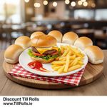 A 9-inch round bagasse plate holding a burger and fries, with ketchupdemonstrating its strength and resistance to grease