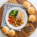 A strong 9-inch white paper plate from Greenspirit holding a generous portion of food without bending, showcasing its durable construction for catering