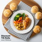 A durable 9-inch Greenspirit paper plate holding a meal of grilled chicken and vegetables, demonstrating its strength for hospitality use.