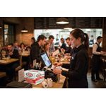 Restaurant staff using discount till rolls credit card rolls in restaurant setting 1