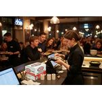 Restaurant staff using discount till rolls credit card rolls in restaurant setting 2