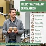 Customer carrying hot drinks in a compostable 2-cup tray outside a coffee shop
