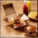 Corrugated burger plate boxes in a takeaway shop, perfect for fresh, on-the-go meals.