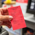 Red_coloured_credit_card_ receipt_in_customers_hand_1.jpeg