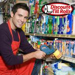 Retail worker applying adhesive price labels using a price gun labeler