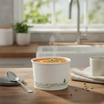8oz White Greenspirit compostable soup containers on a table, filled with hot soup for takeaway, eco-friendly food packaging for cafés and restaurants in Ireland