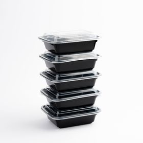 Stackable 16oz microwavable containers with black base and clear lid, designed for space-saving storage."